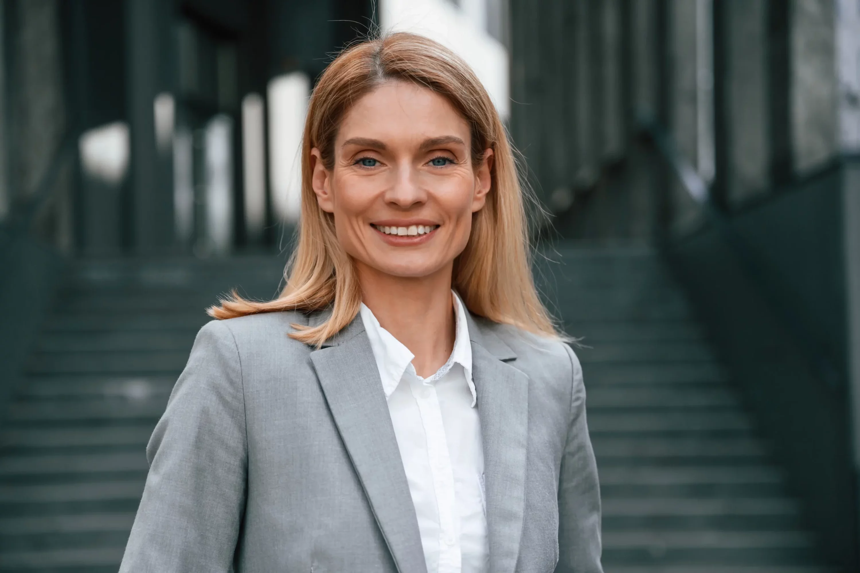 woman-formal-clothes-is-outdoors-near-business-building